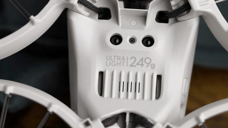 Close-up of a white device labeled "Ultra Light 124g" with two black circular components and a textured surface. It appears to be part of a lightweight electronic or mechanical product.