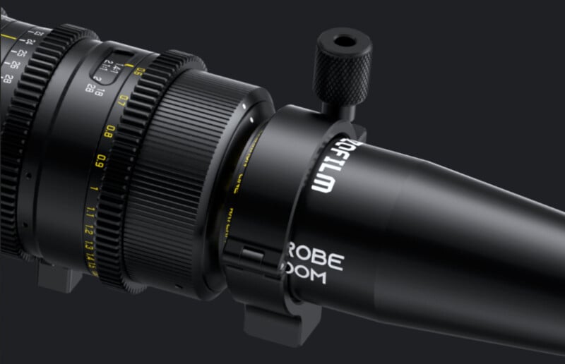 Close-up of a black lens with various focus and zoom rings, featuring yellow markings. The lens also has a small, knurled adjustment knob. Its surface is labeled with "Probe" and "Zoom" in white text.