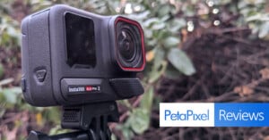 A close-up of an Insta360 camera mounted on a tripod, set against a blurred natural background. The camera has a touchscreen and is labeled "Insta360 Ace Pro 2." The image features an overlay with "PetaPixel Reviews.