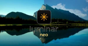 A scenic image of a mountain and forest reflected in a calm lake is divided vertically in half. The left side appears darker and has lower contrast, while the right side is brighter with higher contrast. An icon and logo reading "Luminar Neo" are positioned in the center.