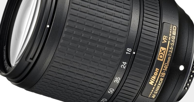 Close-up of a Nikon AF-S DX NIKKOR 18-140mm f/3.5-5.6G ED VR camera lens, showing the zoom ring with focal length markings and part of the VR label. The texture of the grip and the gold Nikon branding are visible.