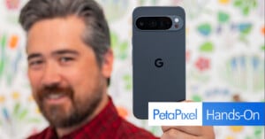 A person with a beard and wearing a red plaid shirt holds up a gray Google smartphone, showing its back with the Google "G" logo. The blurred background features colorful, abstract shapes. The image includes text: "PetaPixel Hands-On.