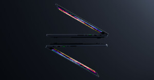 Two sleek, partially closed laptops with colorful screens floating against a dark background, mirrored to create a symmetrical effect. The laptops are positioned at a slight angle, showcasing their thin design and modern technology.