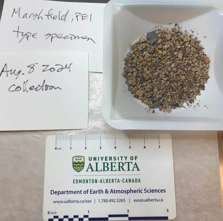 A sample of rocky material labeled "Marshfield, PEI type specimen" is displayed on a tray. The date "Aug. 8, 2024" is noted. Below, a ruler and University of Alberta Earth & Atmospheric Sciences card are visible.