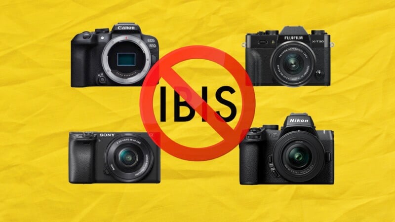 Four cameras from different brands are displayed on a yellow background with a red "no" symbol over the text "IBIS," indicating the cameras do not have in-body image stabilization. Brands shown include Canon, Fujifilm, Sony, and Nikon.